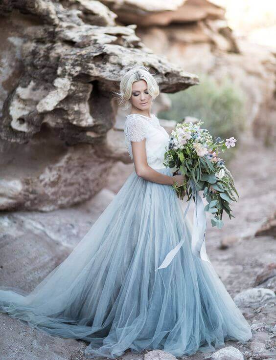 Wedding gowns in different colours can be as colorful or modest as you wish, so here are some lovely shades, degrades and white dresses with dashes of color on the details and we all know the details sure can make quite the difference! See wedwithbliss.com for more