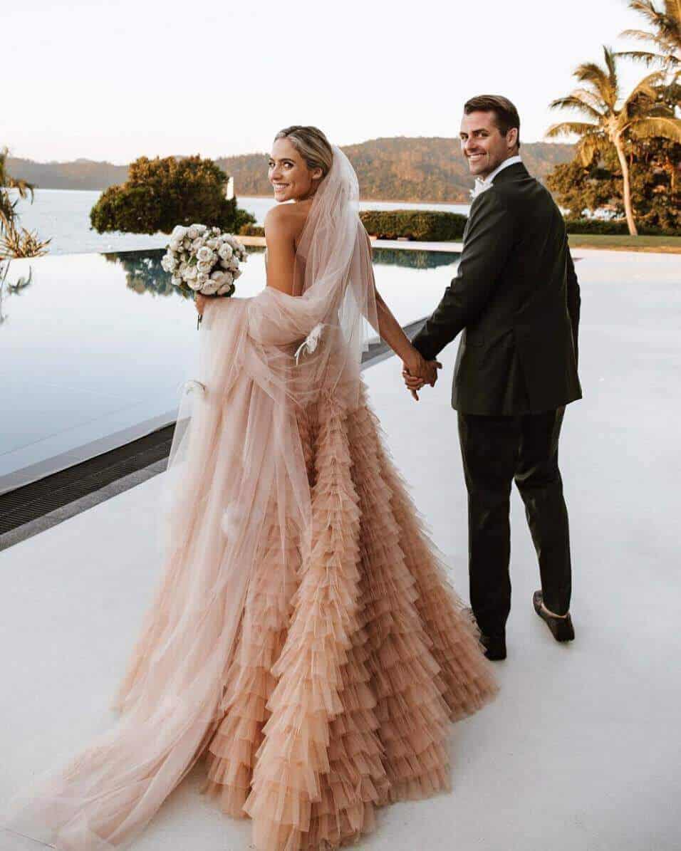 The wedding dress pink colour comes in every shape, size and material to match any tradition. You can go for a divine look with a pink and white lace wedding dress, for instance.
